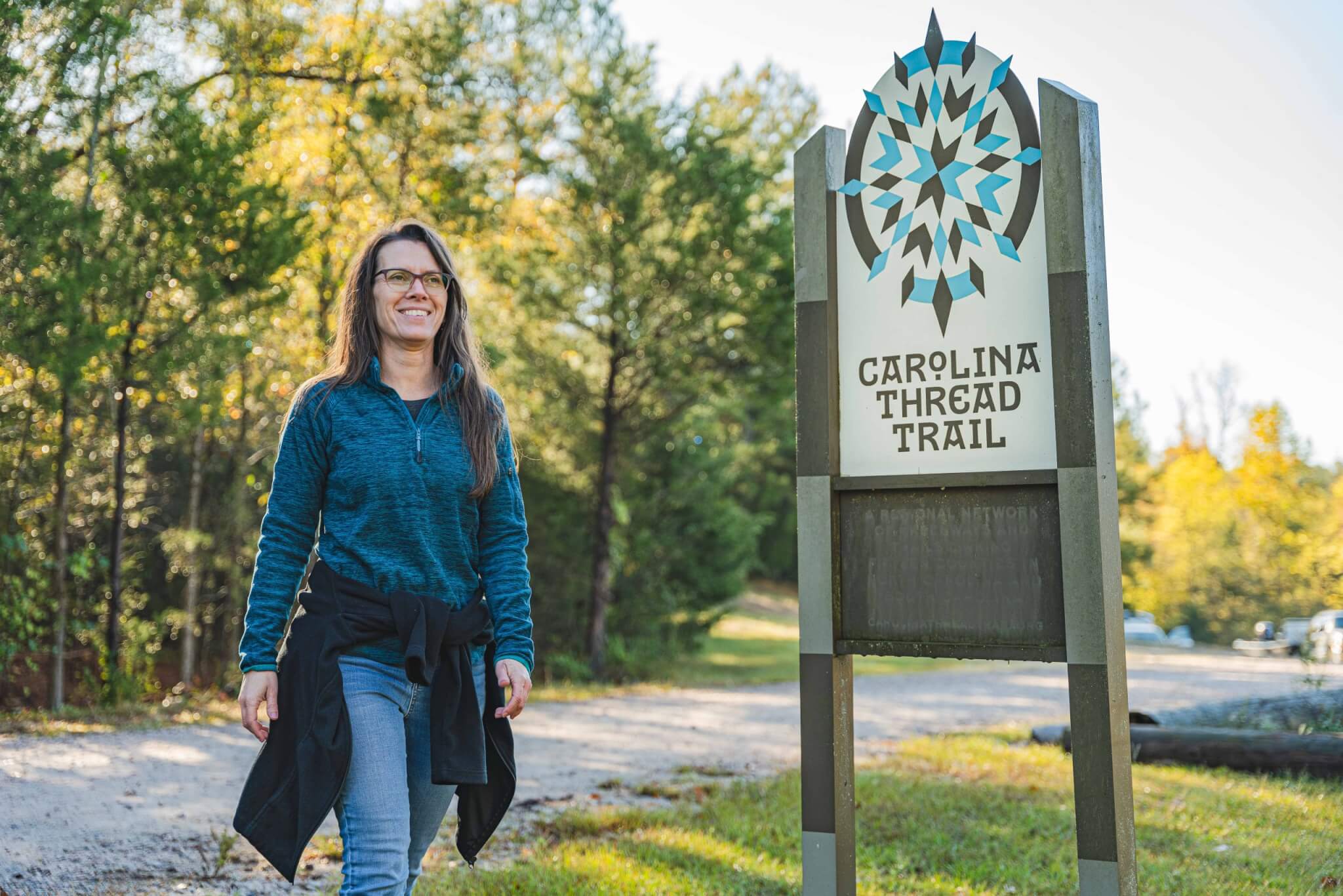 Woman walking along the Carolina Thread Trail